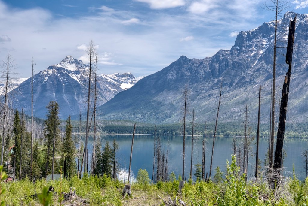 View across Lake McDonald of snow-capped peaks in Glacier National Park.